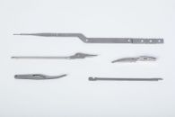 Multiple development parts made via fineblanking, grinding and milling
