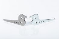 Two levers made via fineblanking, one with and one without plating